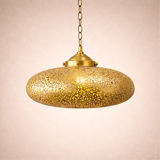 Lit Moroccan brass saucer pendant lamp suspended on chain