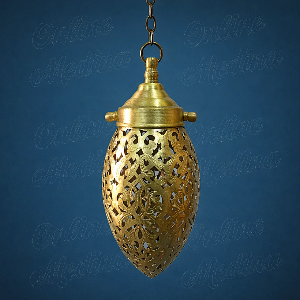 Small handmade Moroccan brass pendant light with openwork details on a deep blue solid background