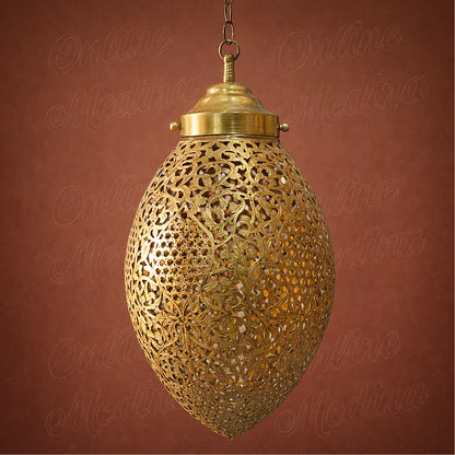 Large handmade Moroccan brass pendant light with detailed openwork design displayed on a warm terracotta background