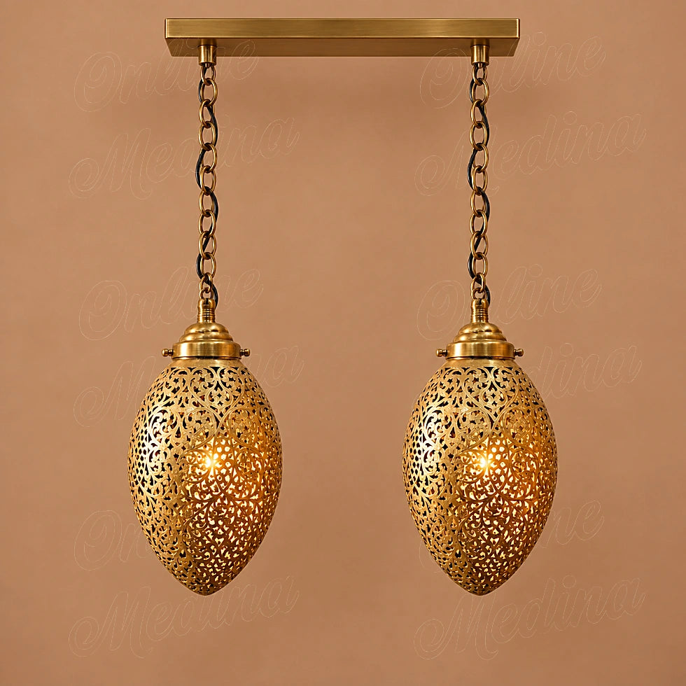 Two glowing openwork brass ovoid pendants on a rectangular canopy against a tan background