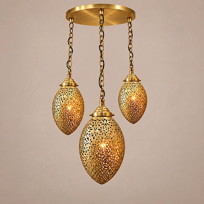 Three glowing brass ovoid pendants at staggered heights on a round canopy against a beige background