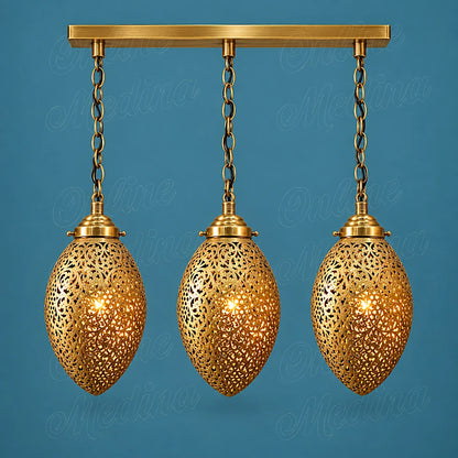 Three glowing openwork brass ovoid pendants on a rectangular canopy against a blue background