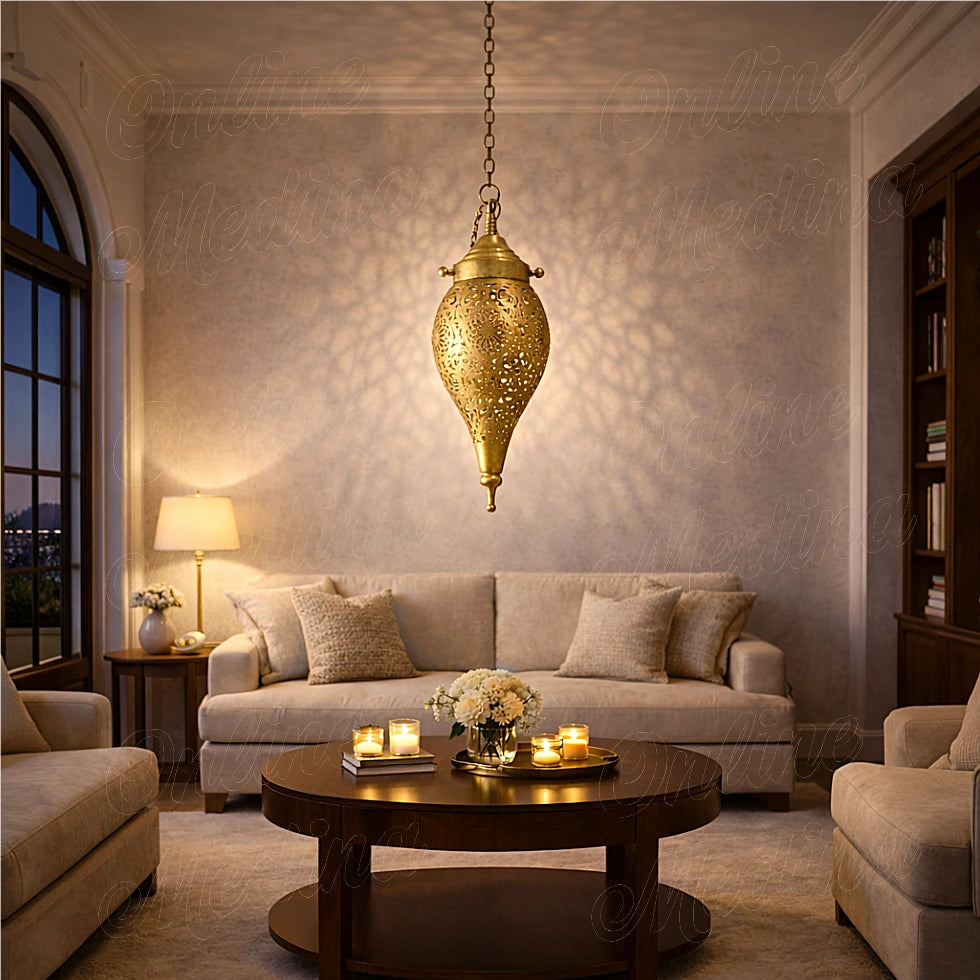 Moroccan brass teardrop pendant light casting warm patterned shadows in an elegant living room at night