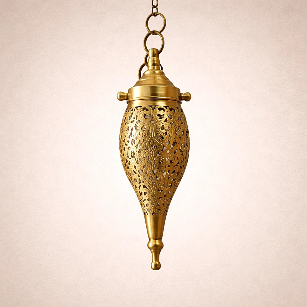 Close up of handmade Moroccan brass teardrop pendant light showing detailed openwork pattern