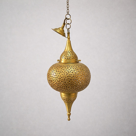 Handmade Moroccan brass pendant light with intricate geometric openwork on neutral studio background