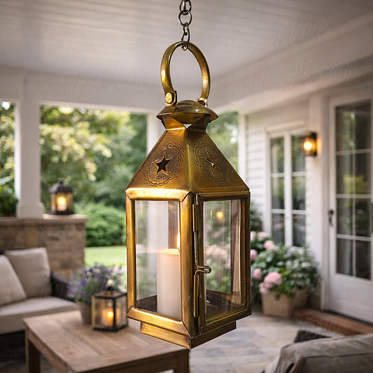 Antique brass Moroccan candle lantern with glass panels hanging in patio creating warm candlelight ambiance