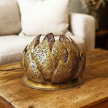 Handcrafted Moroccan brass lotus lamp on a rustic wooden table in a contemporary living room