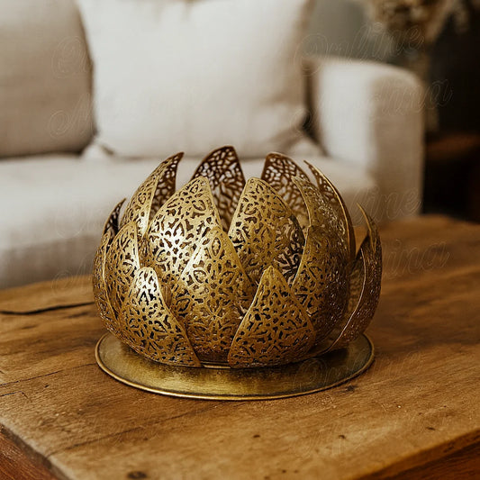Handcrafted Moroccan brass lotus lamp on a rustic wooden table in a contemporary living room