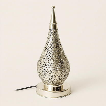 Silver Moroccan pierced metal lamp on a neutral background, teardrop-shaped with intricate filigree patterns and a polished base.