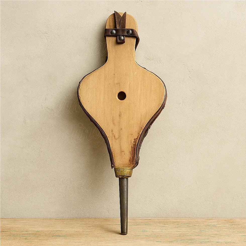 Back view of a handmade Moroccan fireplace bellows showing natural wood texture and brass nozzle.