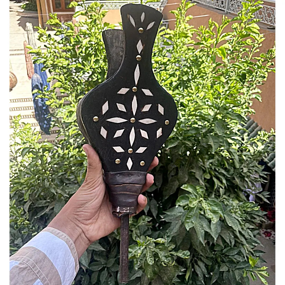 Back view of Moroccan fireplace bellows in blackened wood with decorative white bone inlay and brass studs – elegant and functional home accessory