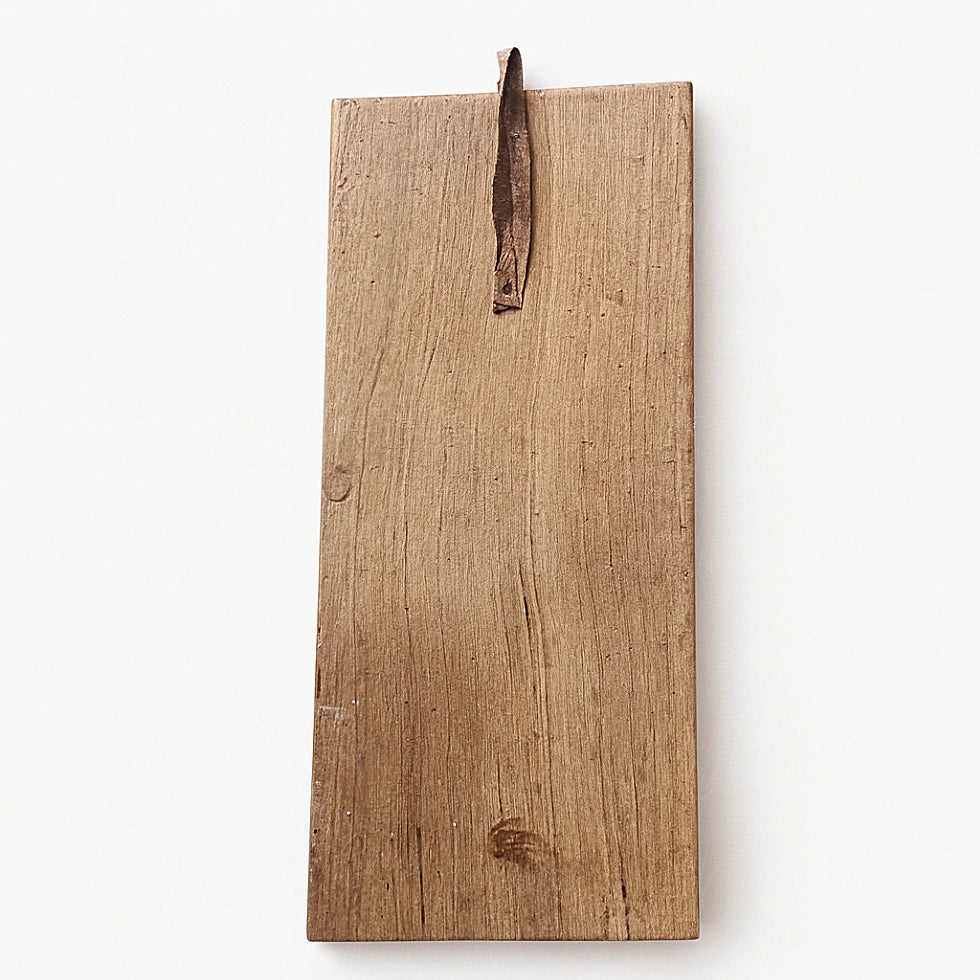 Back view of Berber wooden wall talisman showing natural cedar wood grain and leather hanging loop