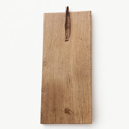 Back view of Berber wooden wall talisman showing natural cedar wood grain and leather hanging loop