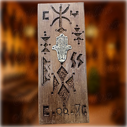 Berber wooden wall amulet in cedar wood with carved Amazigh motifs and small central Hamsa hand, traditional Moroccan protective wall decor by Online Medina