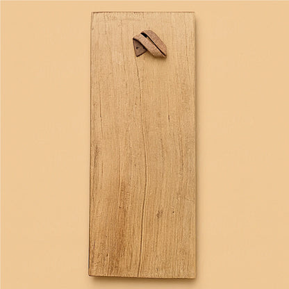 Back view of the same handcrafted Moroccan cedar wood wall amulet showing the natural wood grain and the leather hanging strap on a beige background.