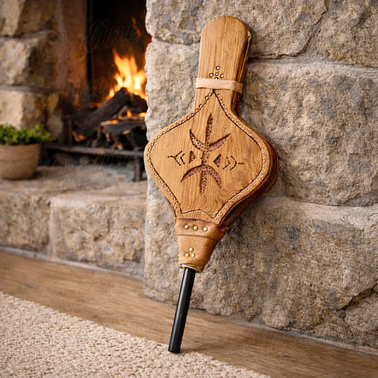 Moroccan handcrafted wooden fire bellows with Amazigh engraved motif used near a fireplace