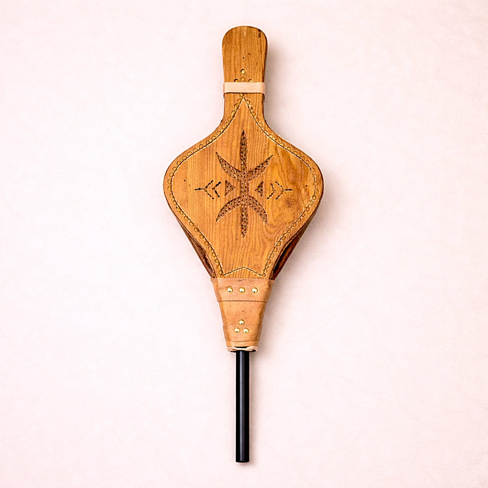 Handmade Moroccan wooden fire bellows featuring traditional Amazigh geometric carving