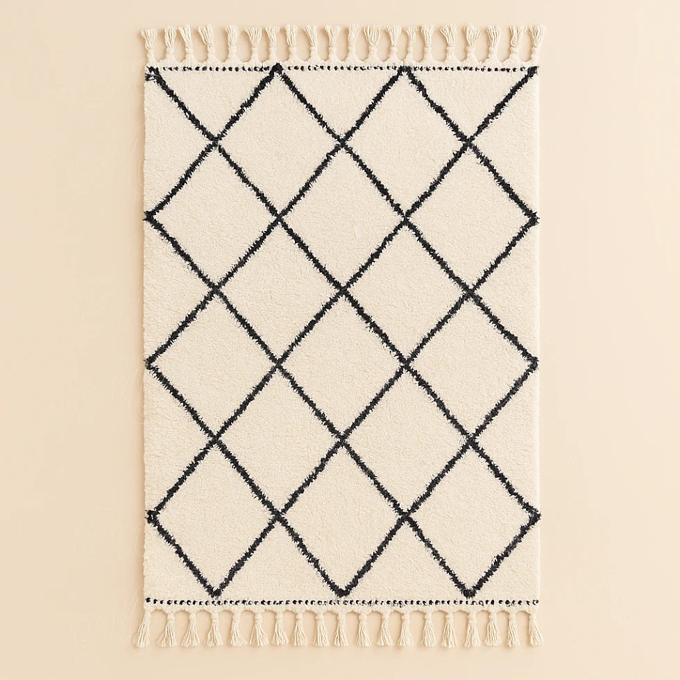 Handwoven Moroccan Beni Ourain rug with black diamond pattern on cream wool background, crafted by artisans for Online Medina.