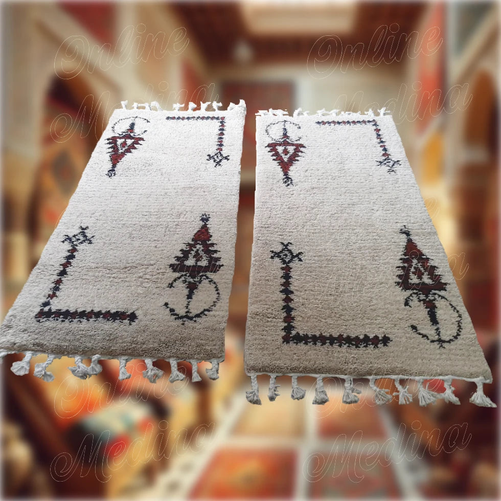 Two authentic Khelala Berber wool rugs in cream with black and brown motifs — perfect handmade decor for traditional Moroccan style.
