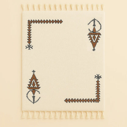 Full view of the Khelala Moroccan wool rug, handwoven beige base with brown geometric motifs