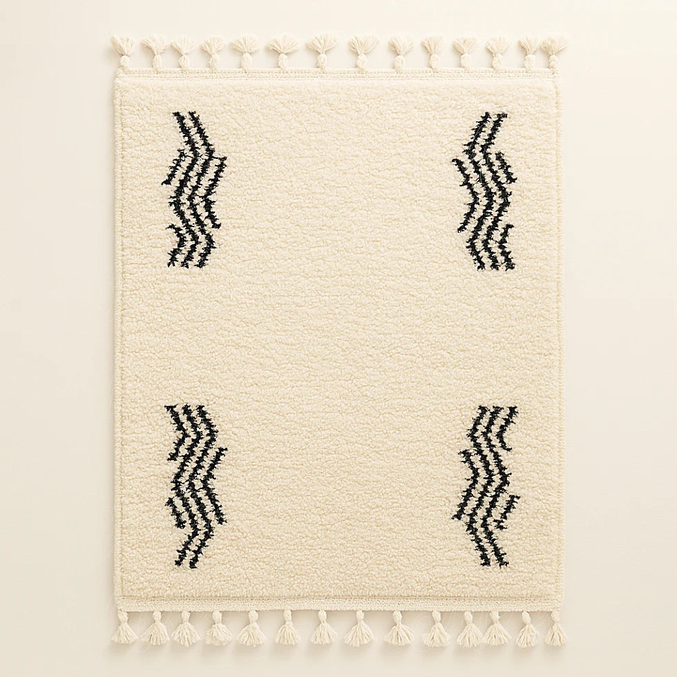 Cream Berber wool rug with four black zigzag wave motifs and fringes, handmade by Moroccan artisans