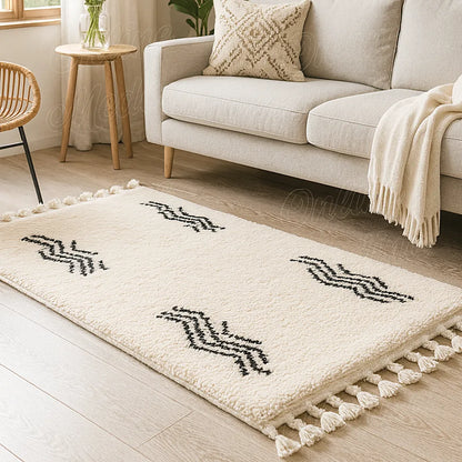 Cream wool Berber rug with black zigzag motifs and fringes in a cozy modern living room with beige sofa and natural light