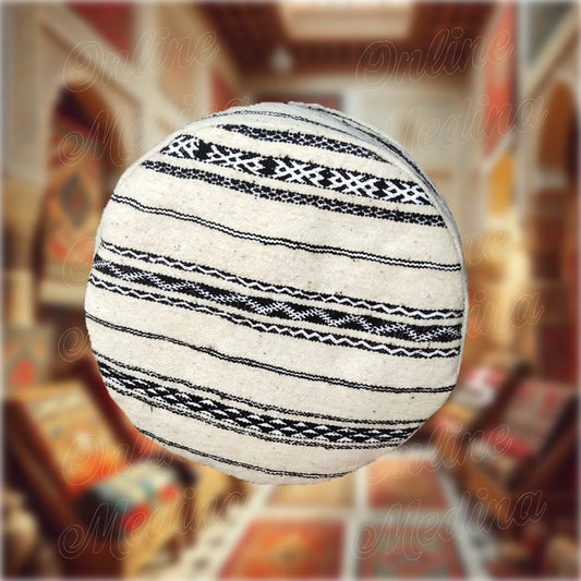 Round Berber pouf in handwoven wool with black and white geometric patterns — a perfect blend of authenticity and style.