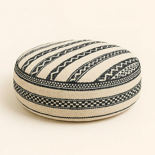 Handmade Moroccan Berber pouf in black and white wool fabric with geometric motifs, photographed on a neutral background for e-commerce product presentation.
